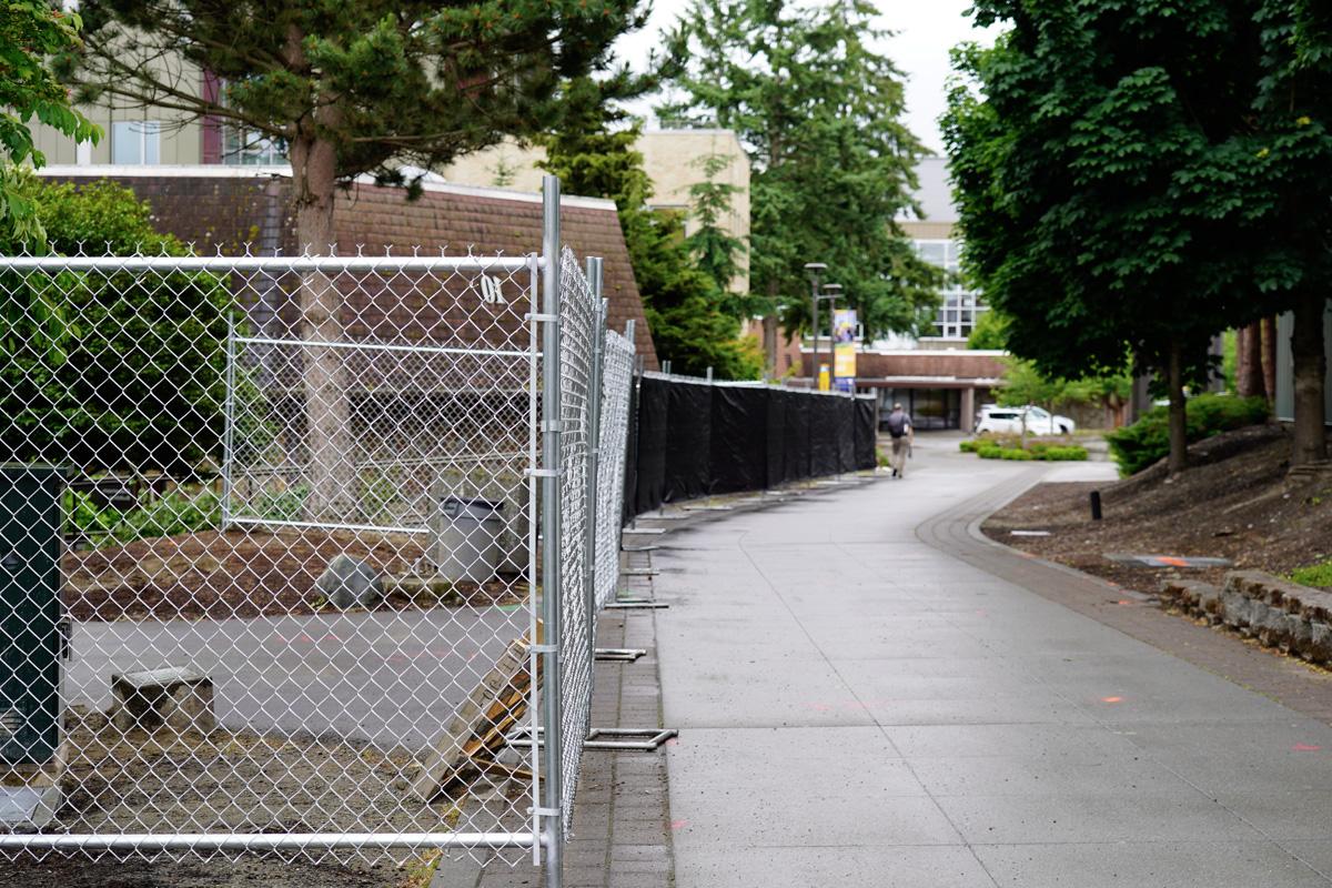 Campus walkway, looking towards Building 15, with a fence along the walkway blocking access to Building 10